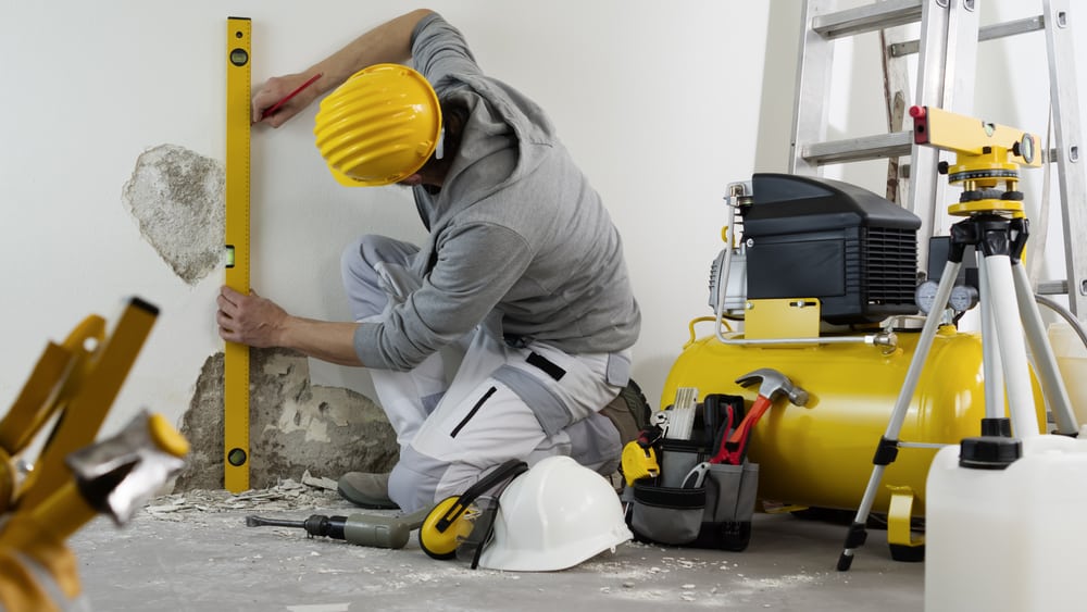 House Renovation Concept Man Worker Looks At The Spirit Level